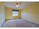 Bright bedroom features neutral carpet, white closet doors, and natural light from the window at 5060 Ne 4Th St, Ocala, FL 34470