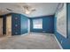 Blue bedroom with carpeted floor and ceiling fan at 5060 Ne 4Th St, Ocala, FL 34470