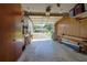 Spacious garage with ample storage and organization, featuring work bench and exterior view at 5060 Ne 4Th St, Ocala, FL 34470