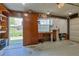Functional garage space featuring a workbench, storage cabinets, and outdoor access at 5060 Ne 4Th St, Ocala, FL 34470