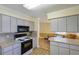 Bright kitchen with gray cabinets and stainless steel microwave at 5060 Ne 4Th St, Ocala, FL 34470
