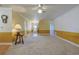 Bright living room with carpeted flooring, neutral paint, and a ceiling fan, ready for furnishings at 5060 Ne 4Th St, Ocala, FL 34470