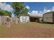 A backyard shed with a covered carport offers storage and workspace, enhancing utility at 5060 Ne 4Th St, Ocala, FL 34470