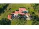 Aerial view showcasing a sprawling estate with a red tile roof and a pool at 6381 Sw 21St Court Rd, Ocala, FL 34471