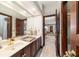 Bathroom with marble countertops, wood cabinets, and updated fixtures at 6381 Sw 21St Court Rd, Ocala, FL 34471