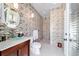 Contemporary bathroom featuring tiled walls, a glass bowl sink, and a walk-in shower at 6381 Sw 21St Court Rd, Ocala, FL 34471
