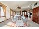 Spacious bedroom suite with sitting area, canopy bed, and access to a kitchenette for ultimate comfort at 6381 Sw 21St Court Rd, Ocala, FL 34471