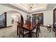 Elegant dining room with a wood table, chandelier, and arched doorway at 6381 Sw 21St Court Rd, Ocala, FL 34471