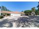 Spacious driveway leading to a pristine white home with a red tile roof and a convenient covered parking area at 6381 Sw 21St Court Rd, Ocala, FL 34471