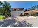 Exterior of the property highlighting a garage with an upper level balcony, a beautiful fountain and lush landscaping at 6381 Sw 21St Court Rd, Ocala, FL 34471