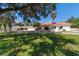 Beautiful house featuring a red tile roof, circular driveway and a sprawling green lawn at 6381 Sw 21St Court Rd, Ocala, FL 34471