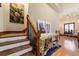 Elegant foyer featuring a staircase, decorative table, and artwork, creating a welcoming entrance at 6381 Sw 21St Court Rd, Ocala, FL 34471