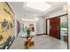 Grand foyer with a glass table, ornate screen, and beautiful woodwork at 6381 Sw 21St Court Rd, Ocala, FL 34471