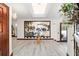 Spacious foyer with light wood floors, a decorative table and an open floor plan at 6381 Sw 21St Court Rd, Ocala, FL 34471