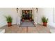 Elegant front door entrance with stone lions, a beautiful rug and decorative plants at 6381 Sw 21St Court Rd, Ocala, FL 34471