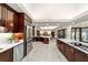 Open kitchen features stainless steel appliances and island with seating, seamlessly flowing to the living area at 6381 Sw 21St Court Rd, Ocala, FL 34471