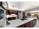 An open concept kitchen boasts stainless steel appliances and a large island with cooktop and seating at 6381 Sw 21St Court Rd, Ocala, FL 34471