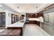 A view of the kitchen with wood cabinets, stainless steel appliances, and a large island with seating at 6381 Sw 21St Court Rd, Ocala, FL 34471