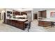 Spacious kitchen featuring dark wood cabinets, large center island, stainless steel appliances, and modern lighting at 6381 Sw 21St Court Rd, Ocala, FL 34471