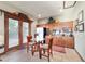 Well-equipped kitchenette featuring cabinetry, stainless steel appliances, and a dining area with backyard view at 6381 Sw 21St Court Rd, Ocala, FL 34471