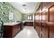 Well-lit laundry room with modern appliances, countertop space, wallpaper, and storage at 6381 Sw 21St Court Rd, Ocala, FL 34471