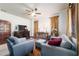 Comfortable living room features stylish blue seating, an ornate console table, and elegant curtains at 6381 Sw 21St Court Rd, Ocala, FL 34471