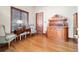 Cozy living room showcasing hardwood floors, classic furnishings, and natural light from a large window at 6381 Sw 21St Court Rd, Ocala, FL 34471