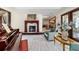 Elegant living room featuring a fireplace, piano, and light wood-look floors at 6381 Sw 21St Court Rd, Ocala, FL 34471