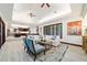 Well-lit living room with neutral tones, stylish decor, and open concept kitchen and entertainment area at 6381 Sw 21St Court Rd, Ocala, FL 34471