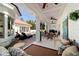 Inviting covered outdoor patio featuring ceiling fans, seating, and a view of the pool and landscaped backyard at 6381 Sw 21St Court Rd, Ocala, FL 34471