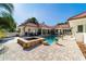 Backyard boasts a swimming pool, spa and sun loungers, complemented by lush landscaping, creating a serene retreat at 6381 Sw 21St Court Rd, Ocala, FL 34471