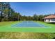 Outdoor tennis court for recreational enjoyment, surrounded by lush greenery at 6381 Sw 21St Court Rd, Ocala, FL 34471