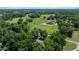 Expansive aerial view of a sprawling property featuring green pastures, mature trees, and a beautiful home at 645 Sw 48Th Ln, Ocala, FL 34471