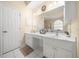 Bathroom featuring double sink vanity with white cabinetry and tiled flooring at 645 Sw 48Th Ln, Ocala, FL 34471