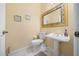 Half bathroom with a pedestal sink, decorative mirror, and tile flooring at 645 Sw 48Th Ln, Ocala, FL 34471