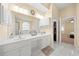 Bathroom with double vanity, walk in closet and tile flooring at 645 Sw 48Th Ln, Ocala, FL 34471