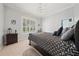 Bright bedroom with a ceiling fan, carpet floors, and a large window providing natural light at 645 Sw 48Th Ln, Ocala, FL 34471