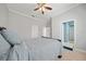 Spacious bedroom with a bed, ceiling fan, ensuite bathroom, and ample natural light at 645 Sw 48Th Ln, Ocala, FL 34471