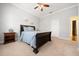 Cozy bedroom featuring carpet floors, a ceiling fan, and a side table at 645 Sw 48Th Ln, Ocala, FL 34471
