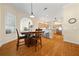 Sunlit dining area showcasing hardwood floors, and views to a modern kitchen at 645 Sw 48Th Ln, Ocala, FL 34471