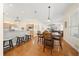Open-concept dining area with wood floors, adjacent to a spacious kitchen and living room with fireplace at 645 Sw 48Th Ln, Ocala, FL 34471