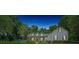 Beautiful home featuring three dormer windows, complemented by lush landscaping, on a tranquil, clear evening at 645 Sw 48Th Ln, Ocala, FL 34471
