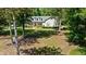 Charming two-story home with dormer windows, lush front lawn, and mature trees providing shade at 645 Sw 48Th Ln, Ocala, FL 34471