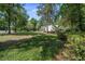 Exterior of home featuring a beautifully landscaped front lawn, mature trees, and inviting curb appeal at 645 Sw 48Th Ln, Ocala, FL 34471