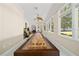 Bright game room with shuffleboard table, natural light, and access to outdoor views at 645 Sw 48Th Ln, Ocala, FL 34471