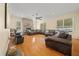 Expansive living room with a stone fireplace, hardwood floors, and leather sofas at 645 Sw 48Th Ln, Ocala, FL 34471