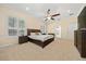 Inviting main bedroom featuring carpet flooring, neutral colors, ceiling fan, and ample natural light at 645 Sw 48Th Ln, Ocala, FL 34471