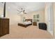 Serene main bedroom with carpet floors, a ceiling fan, and plantation shutters for privacy at 645 Sw 48Th Ln, Ocala, FL 34471