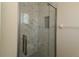 Modern bathroom features an updated tile shower and glass shower door at 6472 Sw 106Th Pl, Ocala, FL 34476