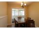 Well-lit dining area offers stylish chandelier, sliding glass door to the Florida Room and neutral walls at 6472 Sw 106Th Pl, Ocala, FL 34476